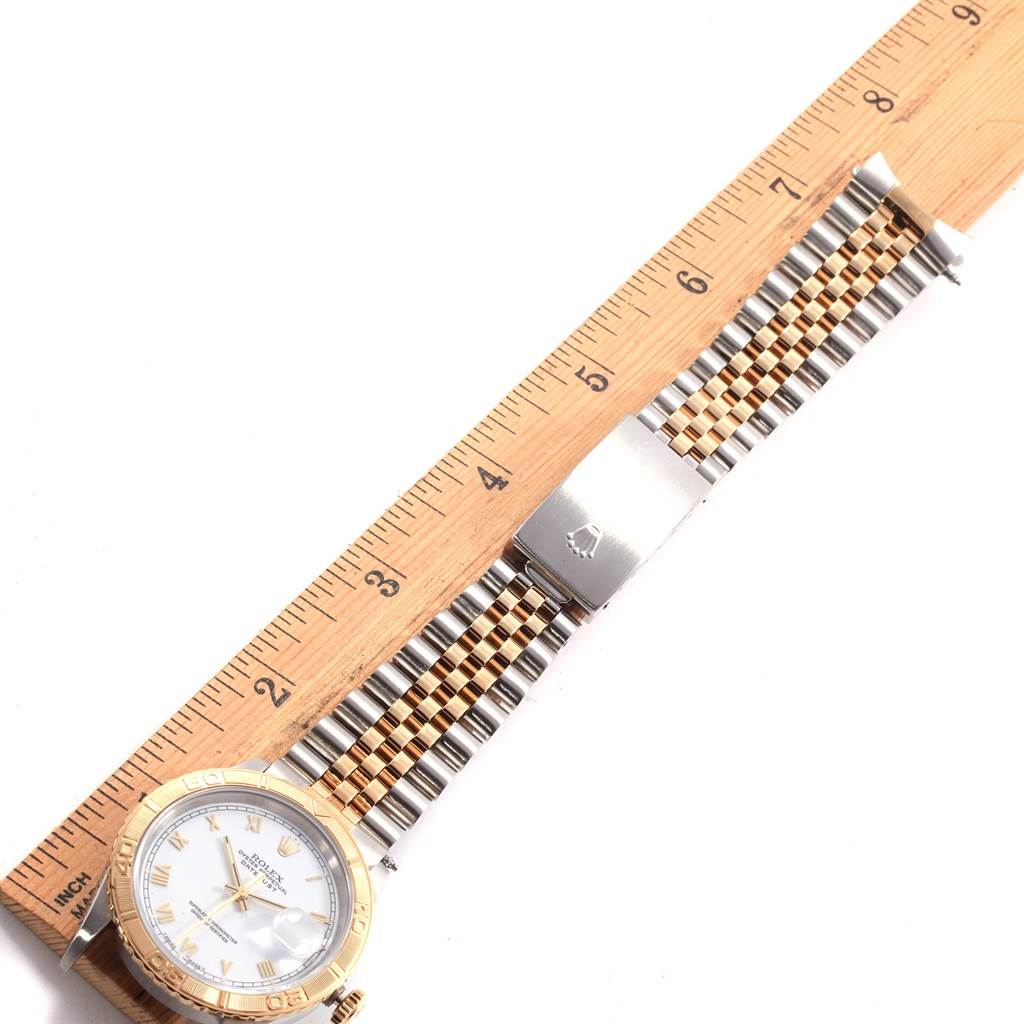 The image shows a Rolex Turn-o-Graph 16263 Men's Steel and Gold (two tone) White Dial 16263 Men's Steel and Gold (two tone) White Dial watch laid flat alongside a ruler, showcasing its face, bezel, and two-tone bracelet.