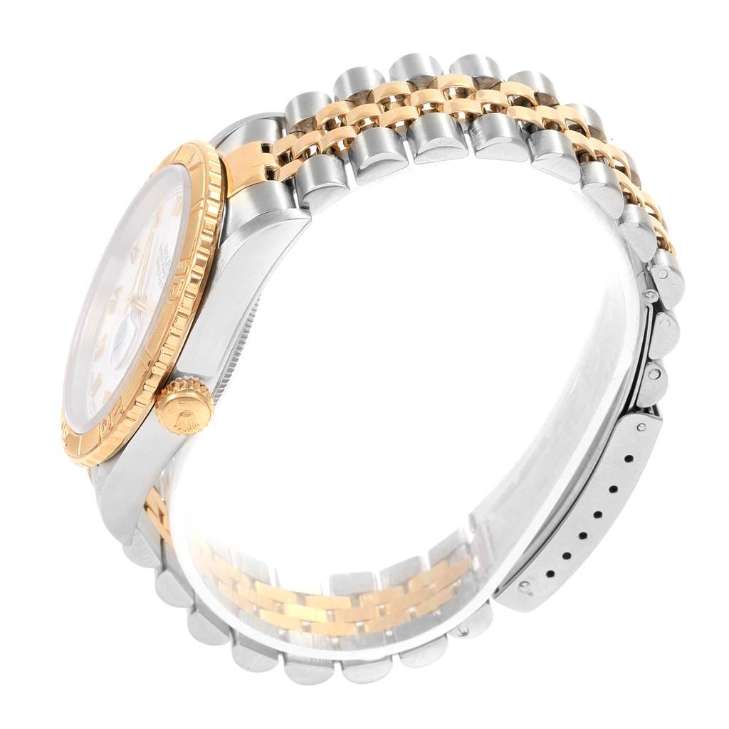 The Rolex Turn-o-Graph 16263 Men's Steel and Gold (two tone) White Dial 16263 Men's Steel and Gold (two tone) White Dial watch is shown from a side angle, highlighting its two-tone bracelet, crown, and bezel.