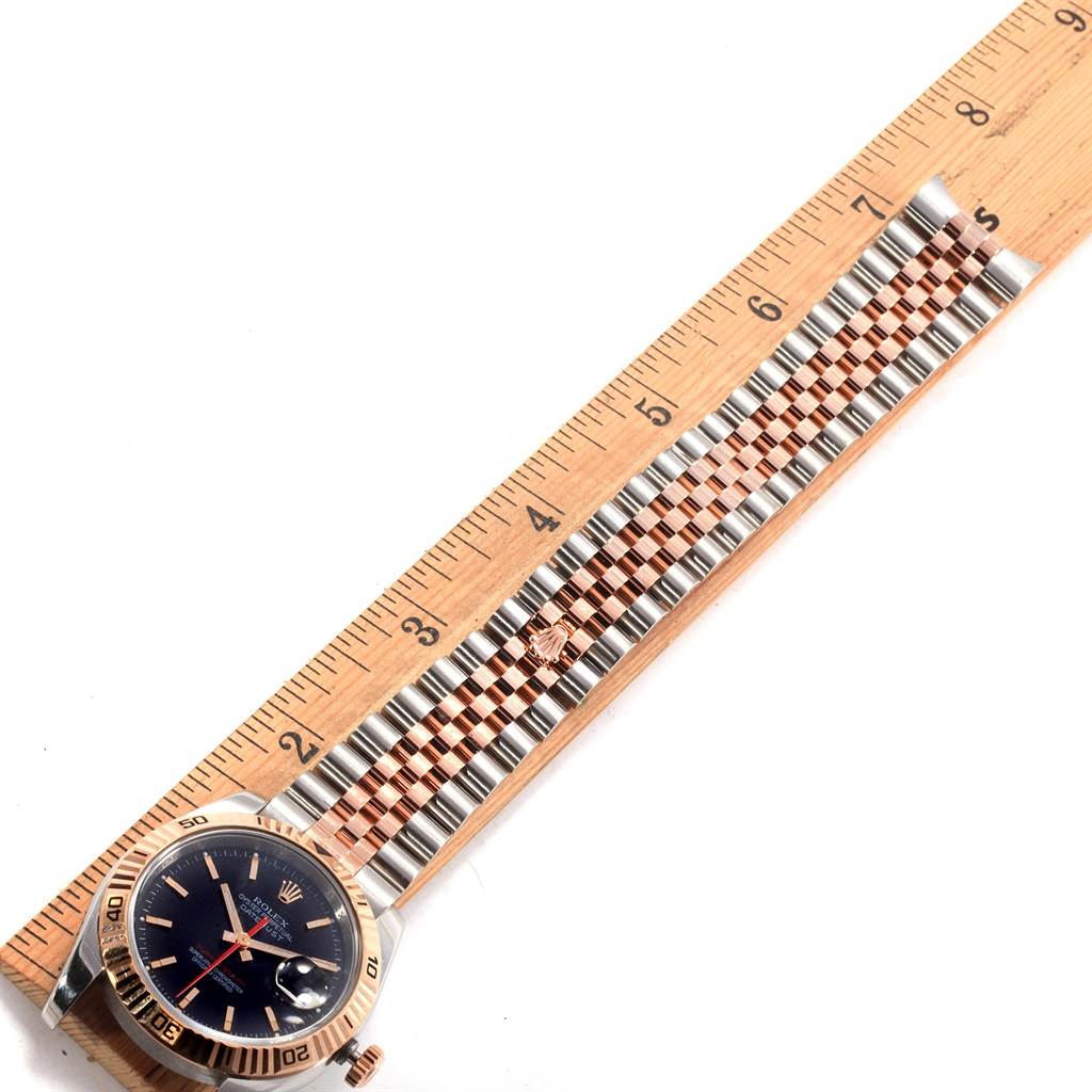 The image shows a Rolex Turn-o-Graph 116261 Men's Stainless Steel Black Dial 116261 Men's Stainless Steel Black Dial watch lying flat with its face, bezel, and two-tone bracelet visible alongside a ruler.