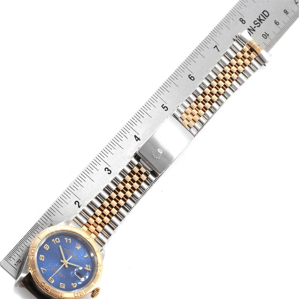 The image shows a horizontally positioned Rolex Turn-o-Graph 16263 Men
s Steel and Gold (two tone) Blue Dial 16263 Men
s Steel and Gold (two tone) Blue Dial watch with a ruler for scale, displaying the watch face and the bracelet.