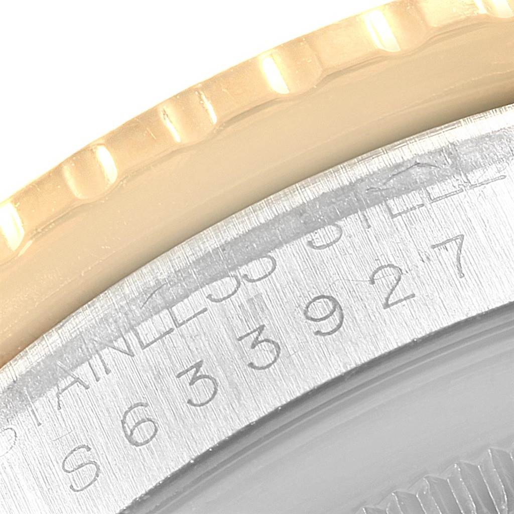 The image shows a close-up angle of the Turn-o-Graph model by Rolex, focusing on the gold bezel and stainless steel case with engraved serial numbers.