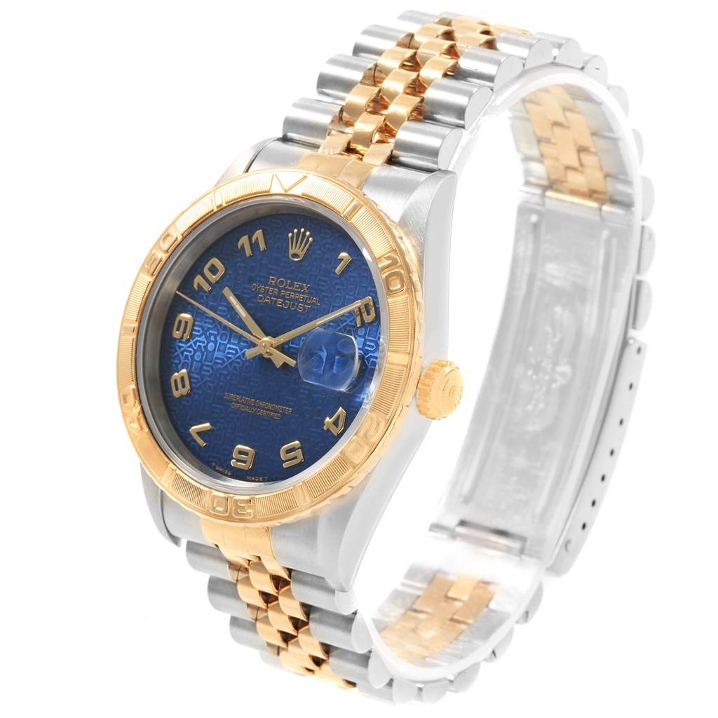 The image shows a Rolex Turn-o-Graph 16263 Men
s Steel and Gold (two tone) Blue Dial 16263 Men
s Steel and Gold (two tone) Blue Dial watch from an angled view, displaying its blue dial, gold bezel, and two-tone bracelet.