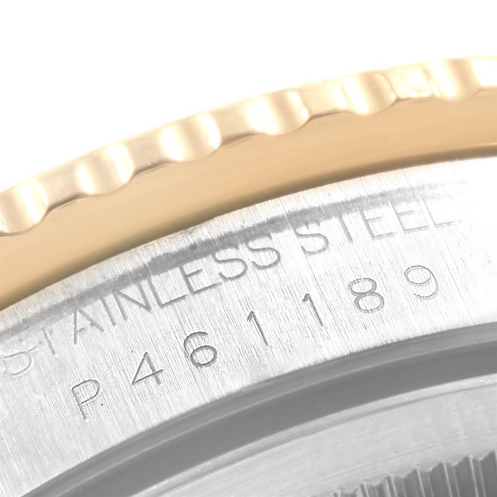 The image shows a close-up of the Rolex Turn-o-Graph 16263 Men's Steel and Gold (two tone) Champagne Dial 16263 Men's Steel and Gold (two tone) Champagne Dial watch's stainless steel casing, focusing on the serial number and part of the bezel.