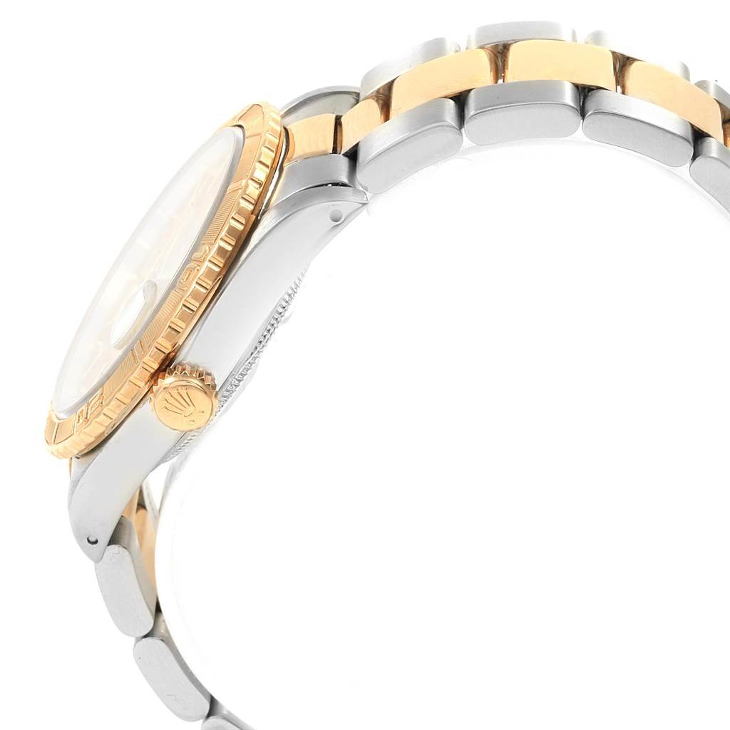 The image shows a side view of a Rolex Turn-o-Graph 16263 Men's Steel and Gold (two tone) Champagne Dial 16263 Men's Steel and Gold (two tone) Champagne Dial watch, highlighting its gold bezel, crown, and two-tone bracelet.