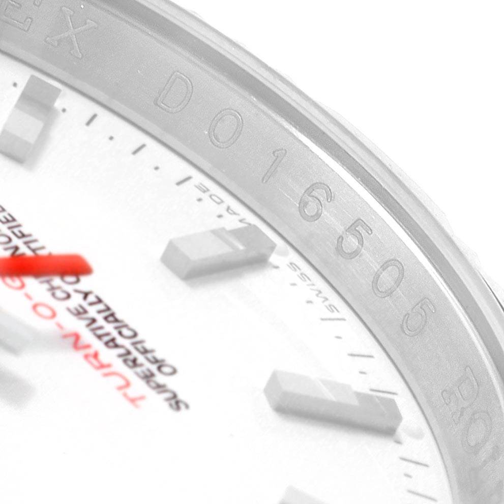 The image shows a close-up of the dial and bezel of a Rolex Turn-o-Graph 116264 Men's Stainless Steel White Dial 116264 Men's Stainless Steel White Dial model, highlighting the indices and some text details.