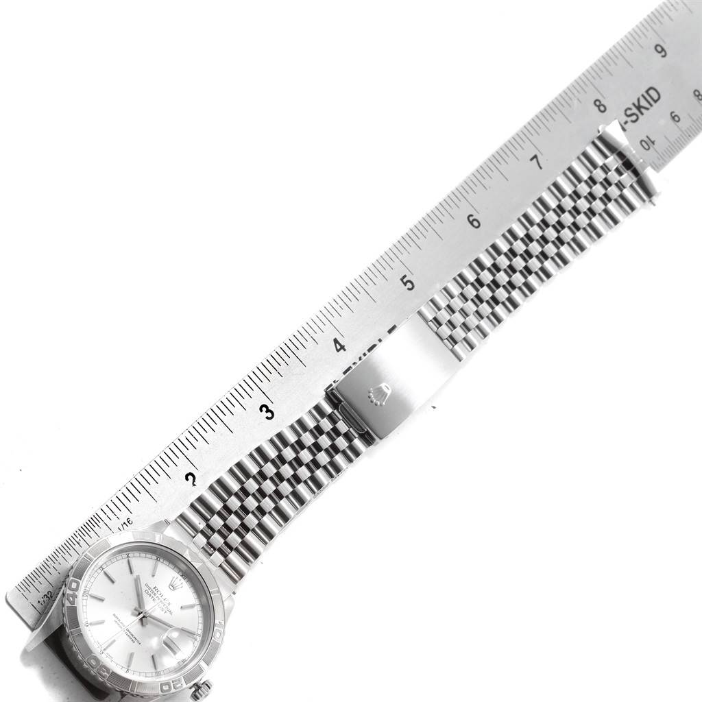 The image shows the full Rolex Turn-o-Graph 16264 Men's Stainless Steel Silver Dial 16264 Men's Stainless Steel Silver Dial watch and its band lying flat, aligned with a ruler.