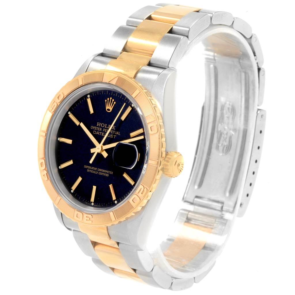 This image shows a Rolex Turn-o-Graph 16263 Men's Steel and Gold (two tone) Black Dial 16263 Men's Steel and Gold (two tone) Black Dial watch at an angled view, highlighting its gold bezel, black dial, and two-tone bracelet.