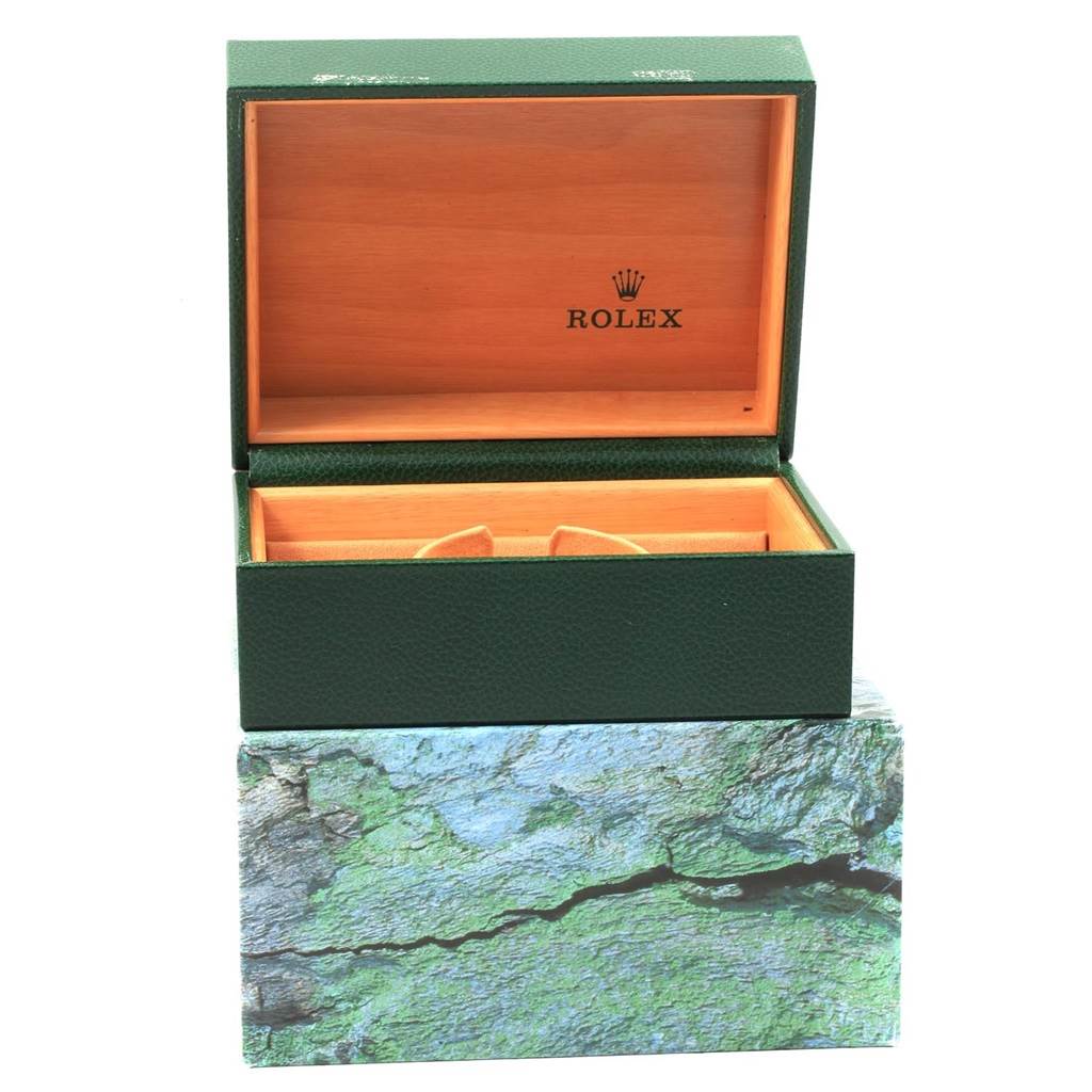 This image shows the open green and wooden packaging box for a Rolex Turn-o-Graph 16263 Men
s Steel and Gold (two tone) Beige Dial 16263 Men
s Steel and Gold (two tone) Beige Dial watch, placed on top of a decorative base.