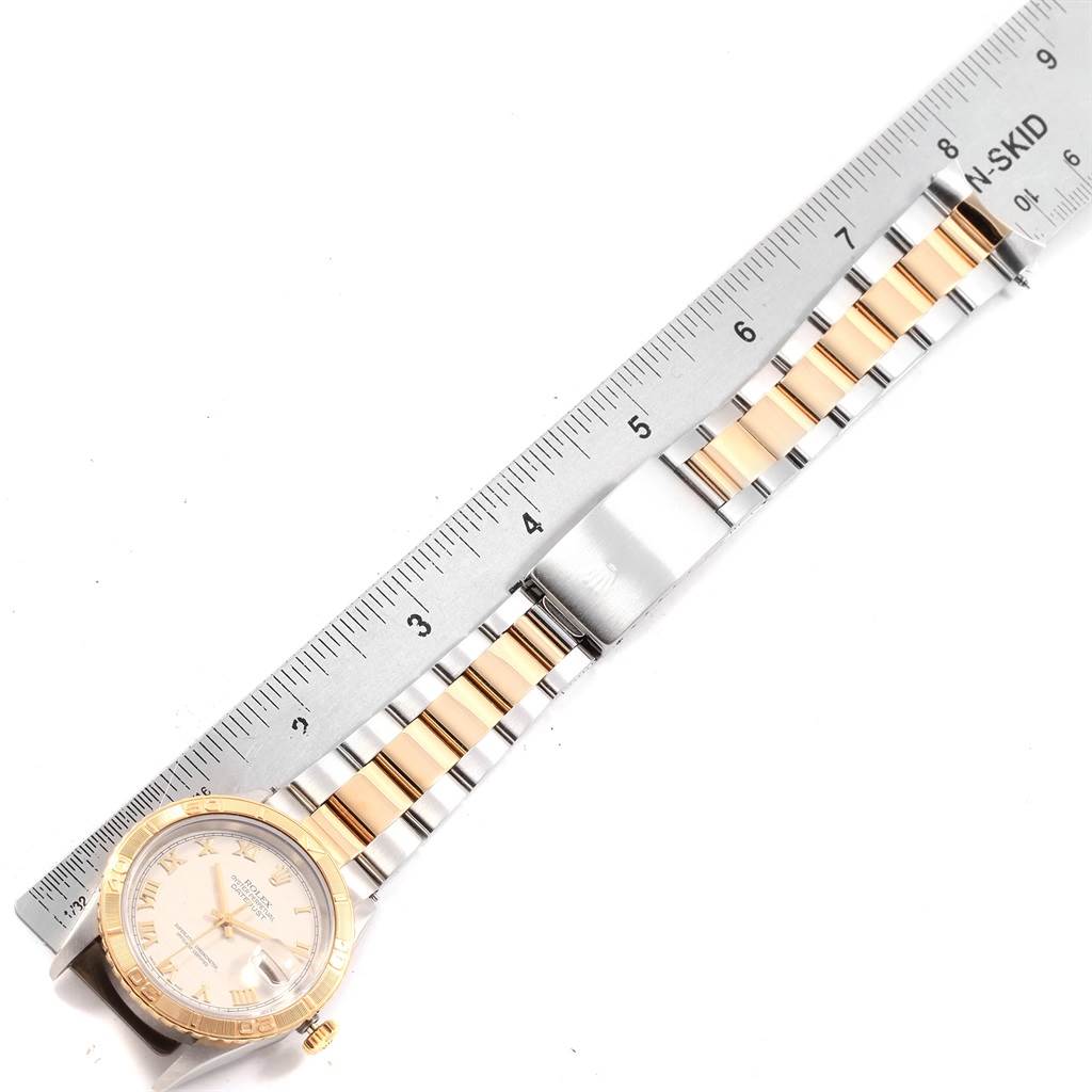 This image shows a Rolex Turn-o-Graph 16263 Men
s Steel and Gold (two tone) Beige Dial 16263 Men
s Steel and Gold (two tone) Beige Dial watch laid flat with a ruler, displaying its bracelet and face from a top-down angle.