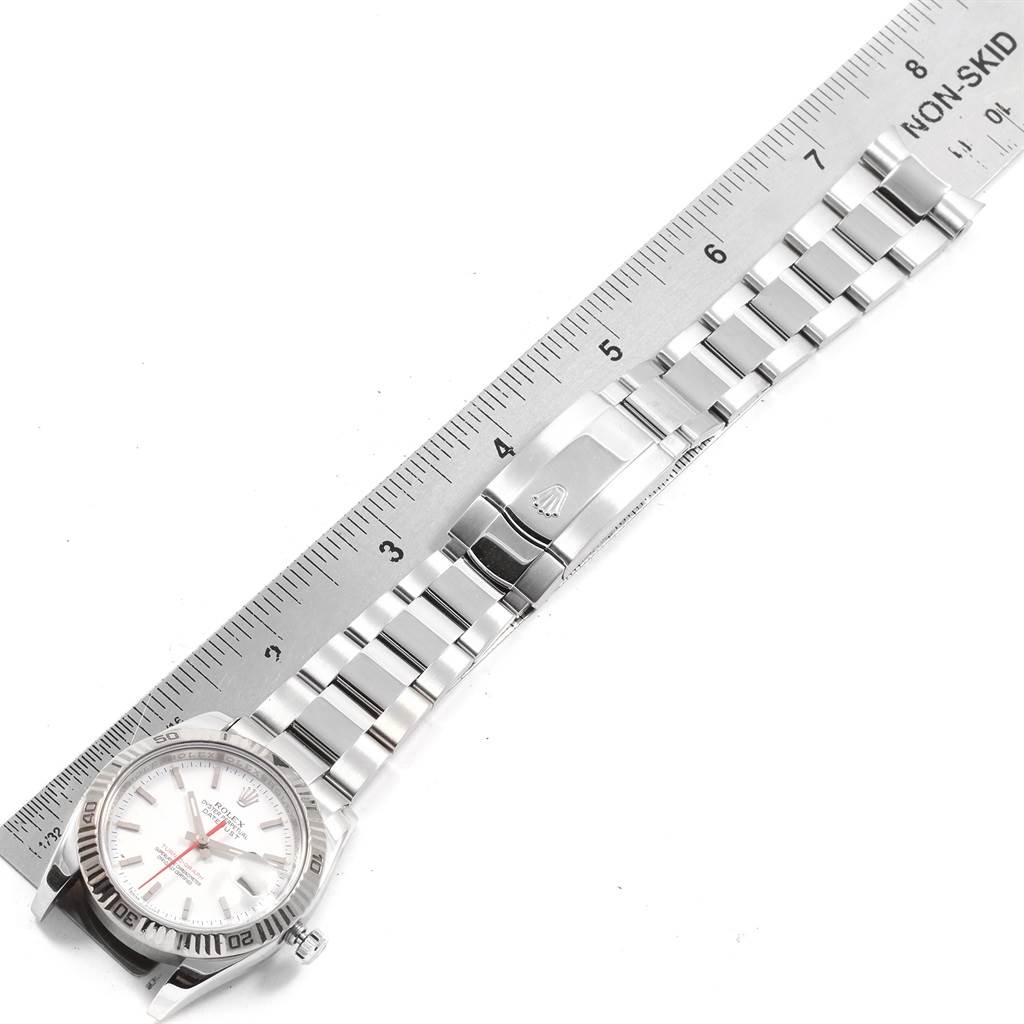 The image shows a top-down view of a Rolex Turn-o-Graph 116264 Men
s Stainless Steel White Dial 116264 Men
s Stainless Steel White Dial watch with the band, clasp, case, and bezel visible, alongside a ruler for measurement.