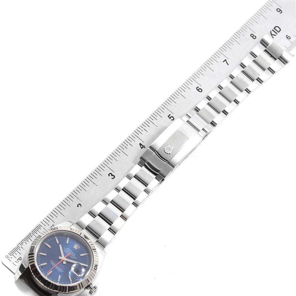 The image shows a top-down view of a Rolex Turn-o-Graph 116264 Men's Stainless Steel Blue Dial 116264 Men's Stainless Steel Blue Dial watch, including its metal bracelet alongside a ruler for scale.