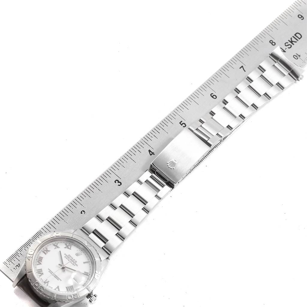 The Rolex Turn-o-Graph 16264 Men
s Stainless Steel White Dial 16264 Men
s Stainless Steel White Dial watch is shown flat with its face, bracelet, and clasp visible alongside a ruler for scale.