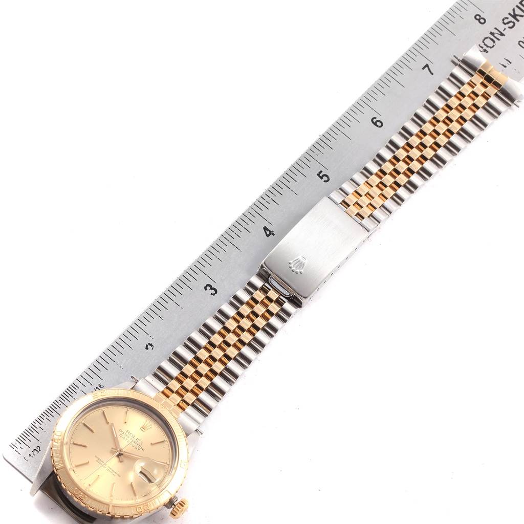 The image shows a Rolex Turn-o-Graph 16253 Men
s Steel and Gold (two tone) Champagne Dial 16253 Men
s Steel and Gold (two tone) Champagne Dial watch laid flat next to a ruler, highlighting the face, bezel, crown, and bracelet.