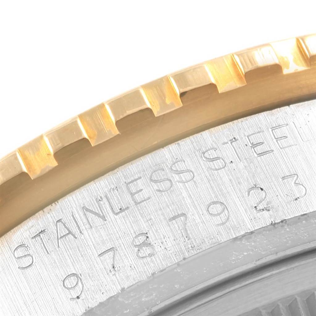 The image shows a close-up angle of the Rolex Turn-o-Graph 16253 Men
s Steel and Gold (two tone) Champagne Dial 16253 Men
s Steel and Gold (two tone) Champagne Dial watch bezel and part of the stainless steel case with engraved text.