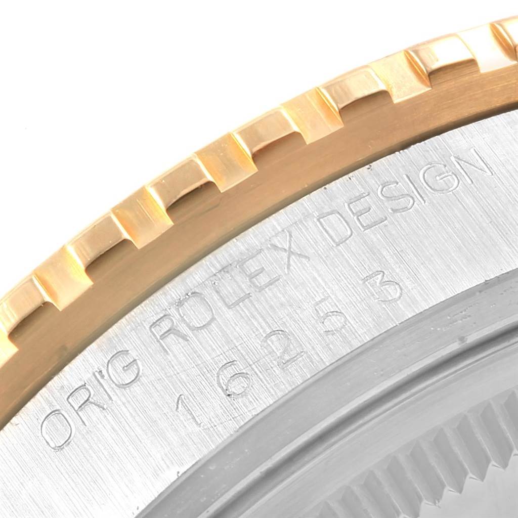 The image shows a close-up of the bezel and engraved case back of a Rolex Turn-o-Graph 16253 Men
s Steel and Gold (two tone) Champagne Dial 16253 Men
s Steel and Gold (two tone) Champagne Dial watch.