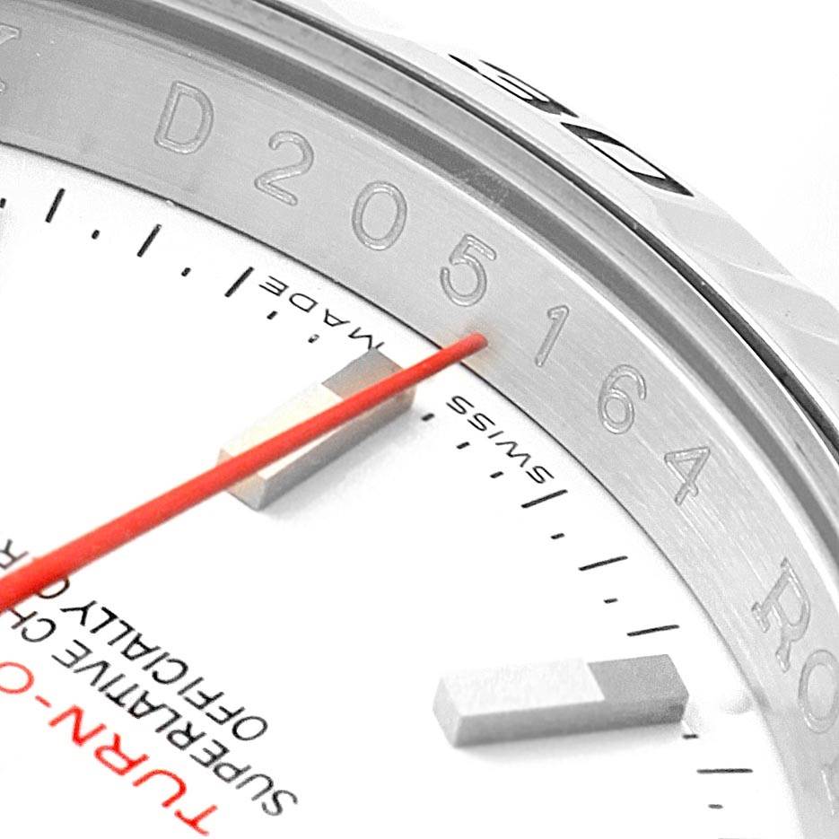 The close-up angle shows the dial, red second hand, and the "Turn-O-Graph" model marking of the Rolex watch.