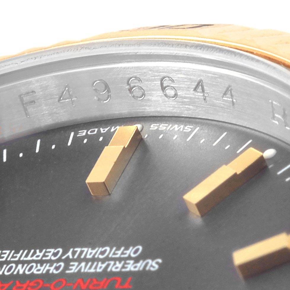 This image shows a close-up of the dial and the engraved serial number on the bezel of a Rolex Turn-o-Graph 116263 Men's Steel and Gold (two tone) Grey Dial 116263 Men's Steel and Gold (two tone) Grey Dial watch.