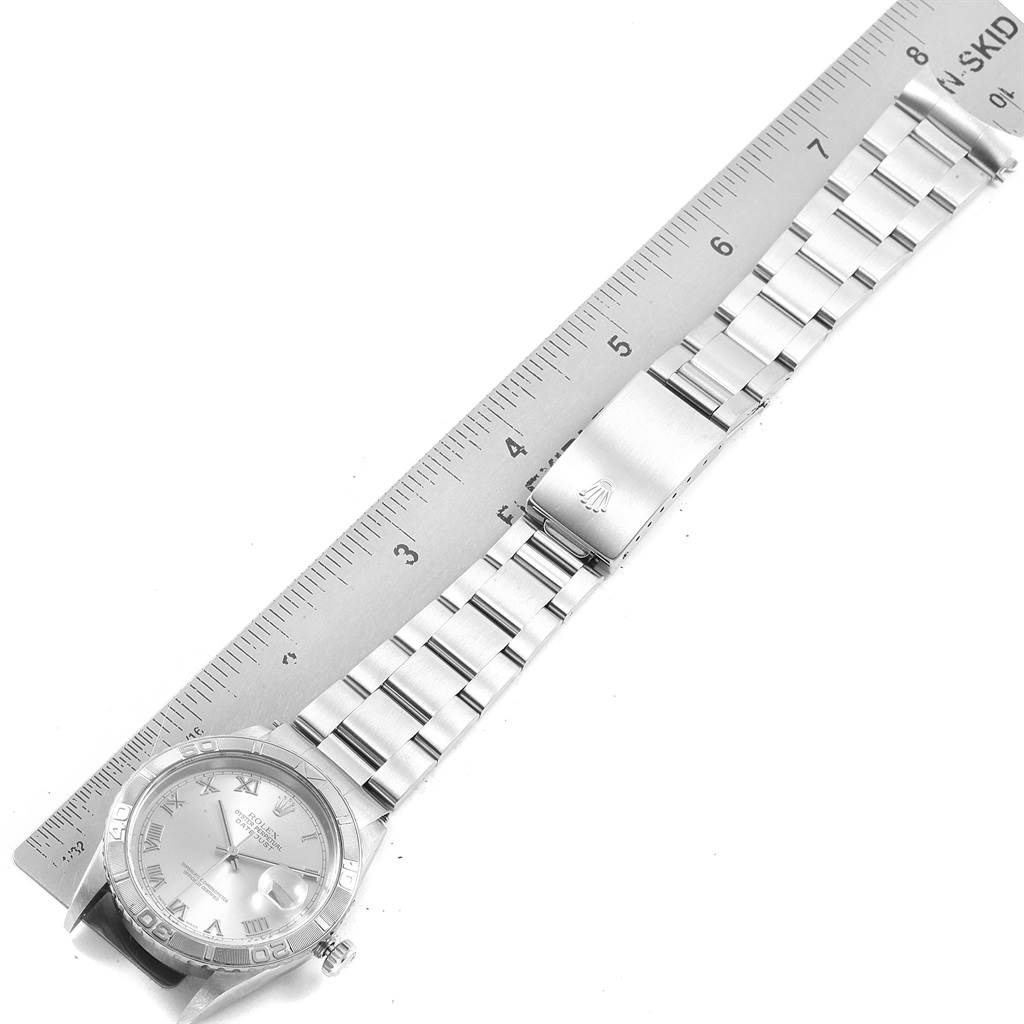 The image shows the Rolex Turn-o-Graph 16264 Men's Stainless Steel Silver Dial 16264 Men's Stainless Steel Silver Dial model watch laid flat next to a ruler, displaying the face and band.