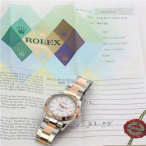 The image shows a Rolex Turn-o-Graph 116261 Men's Stainless Steel Grey Dial 116261 Men's Stainless Steel Grey Dial watch placed on top of its certificate and documentation, highlighting the dial and bracelet.