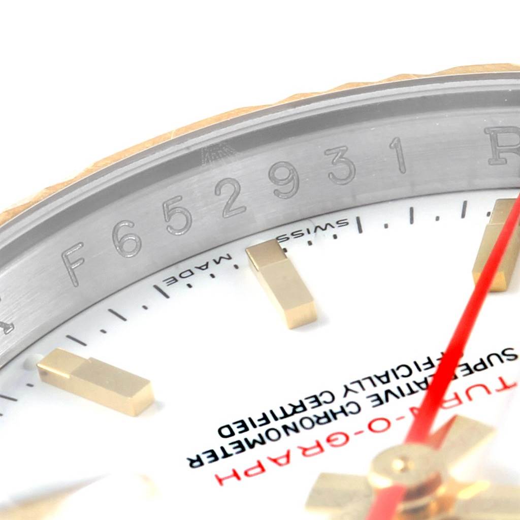 This close-up image of a Rolex Turn-o-Graph 116263 Men's Stainless Steel White Dial 116263 Men's Stainless Steel White Dial watch shows part of the dial, markers, and bezel.