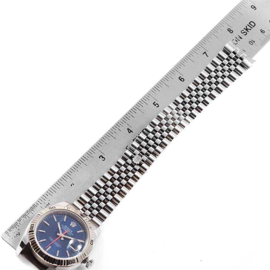 The image shows a Rolex Turn-o-Graph 116264 Men
s Stainless Steel Blue Dial 116264 Men
s Stainless Steel Blue Dial watch with its face and bracelet laid next to a ruler for measurement.