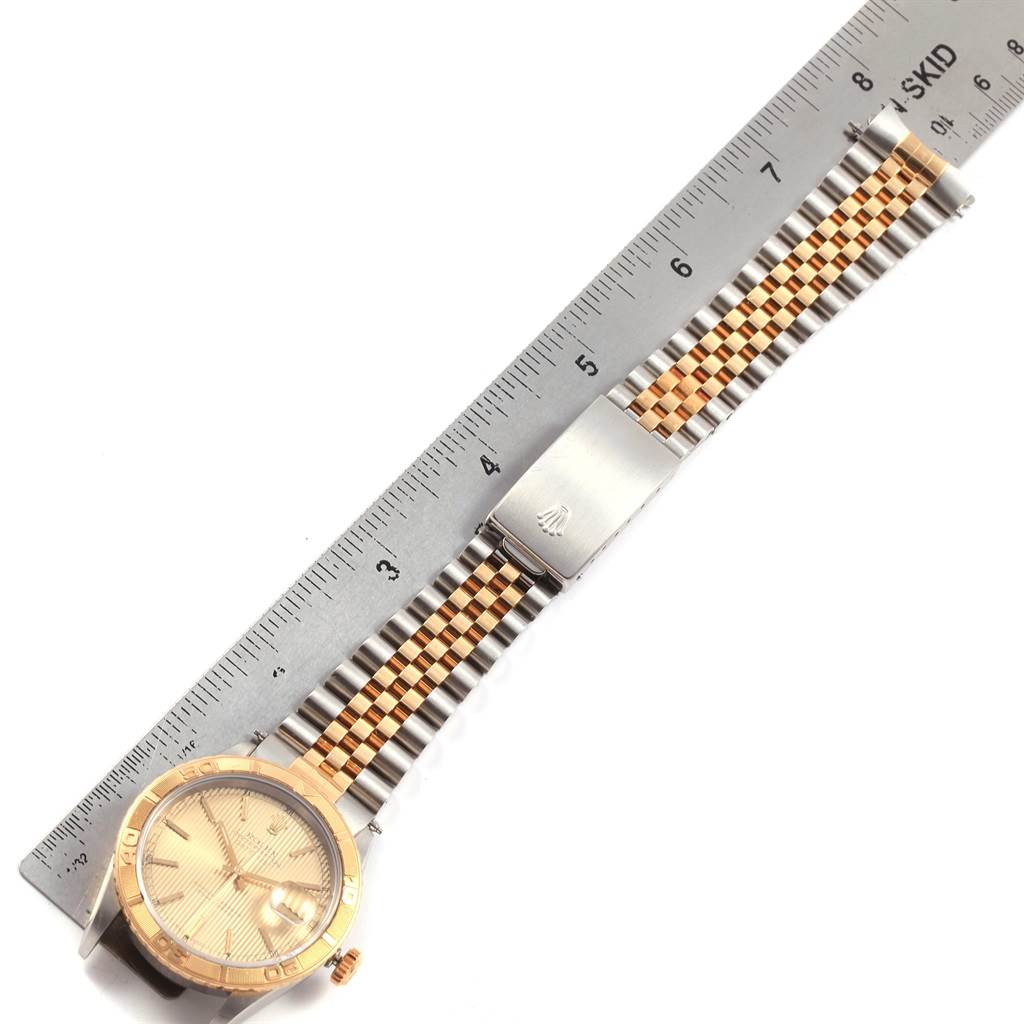 The image shows a top view of a Rolex Turn-o-Graph 16263 Men's Steel and Gold (two tone) Champagne Dial 16263 Men's Steel and Gold (two tone) Champagne Dial watch, including the face, bezel, and two-tone bracelet next to a ruler for scale.