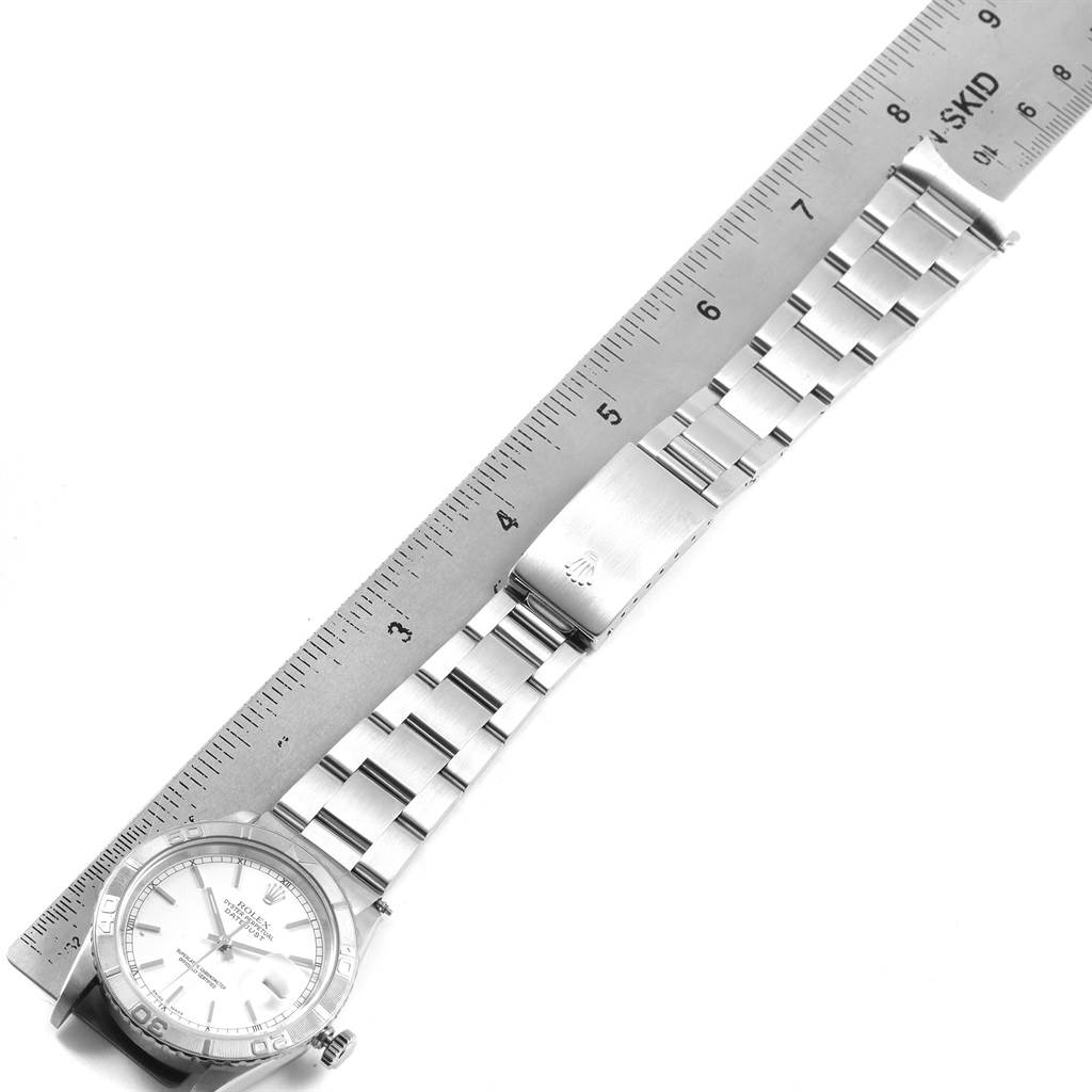 The image shows a Rolex Turn-o-Graph 16264 Men
s Stainless Steel White Dial 16264 Men
s Stainless Steel White Dial watch placed next to a ruler, highlighting the bracelet and clasp.