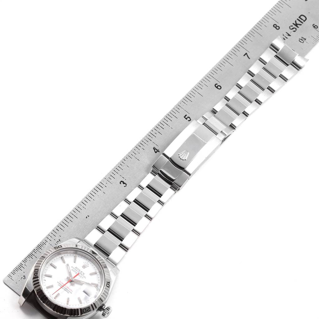 The image shows a top view of a Rolex Turn-o-Graph 116264 Men
s Stainless Steel White Dial 116264 Men
s Stainless Steel White Dial watch with its band aligned next to a ruler for measurement.