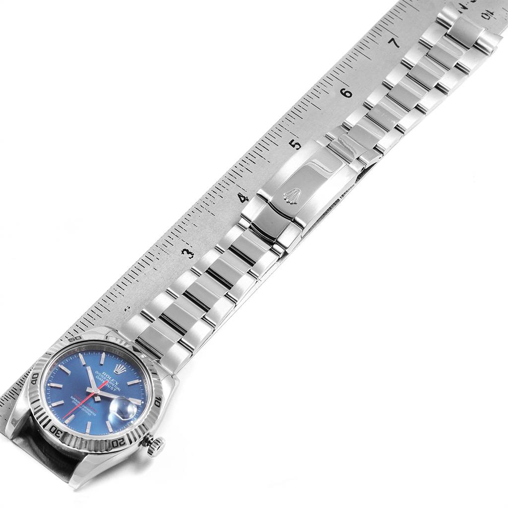 The Rolex Turn-o-Graph 116264 Men
s Stainless Steel Blue Dial 116264 Men
s Stainless Steel Blue Dial model watch is shown from a top view, displaying the face, bezel, bracelet, and clasp alongside a ruler.