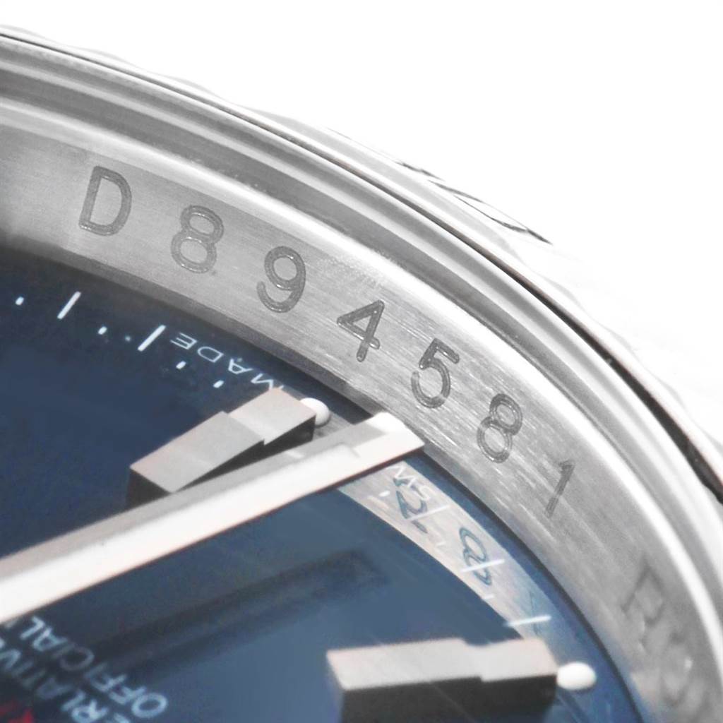 The image shows a close-up of the serial number and part of the face of a Rolex Turn-o-Graph 116264 Men
s Stainless Steel Blue Dial 116264 Men
s Stainless Steel Blue Dial watch.