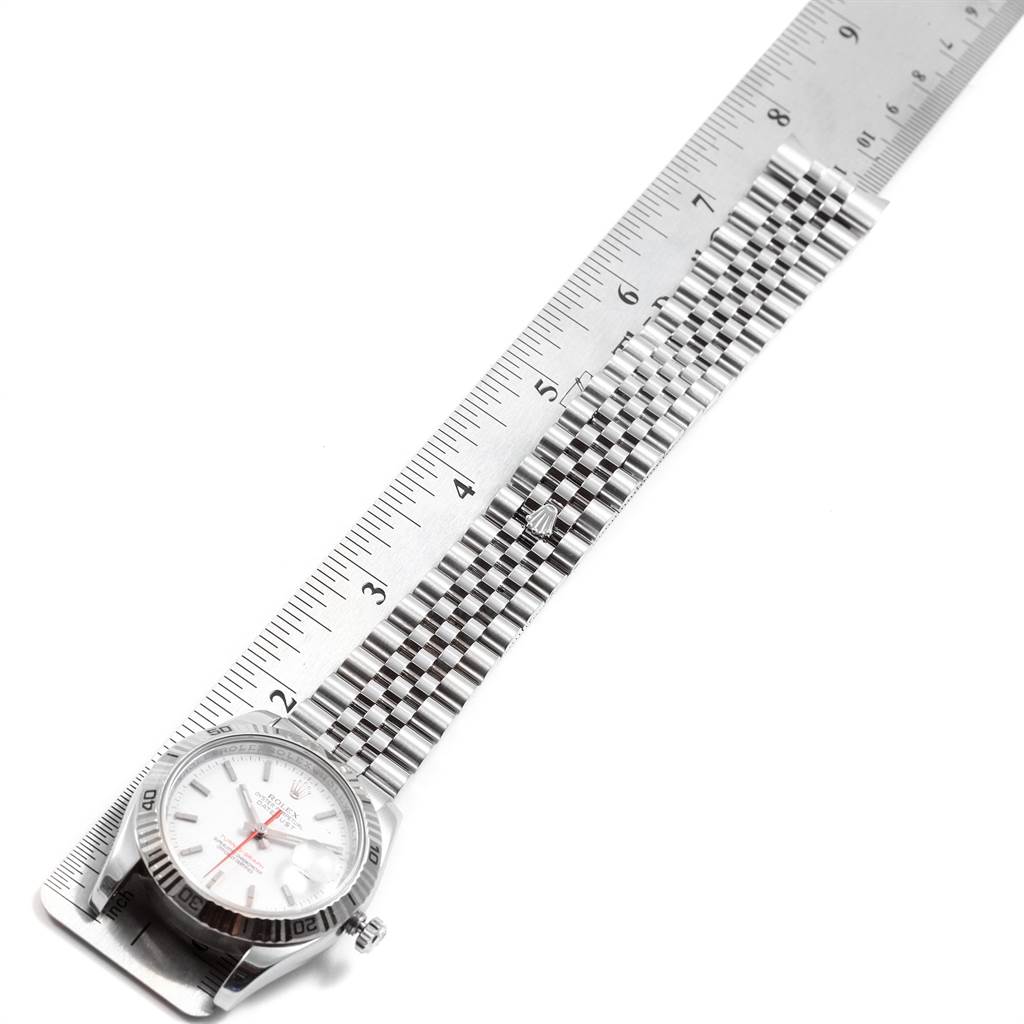 The image shows a Rolex Turn-o-Graph 116264 Men
s Stainless Steel White Dial 116264 Men
s Stainless Steel White Dial watch laid flat with a metal bracelet and a ruler for measurement.