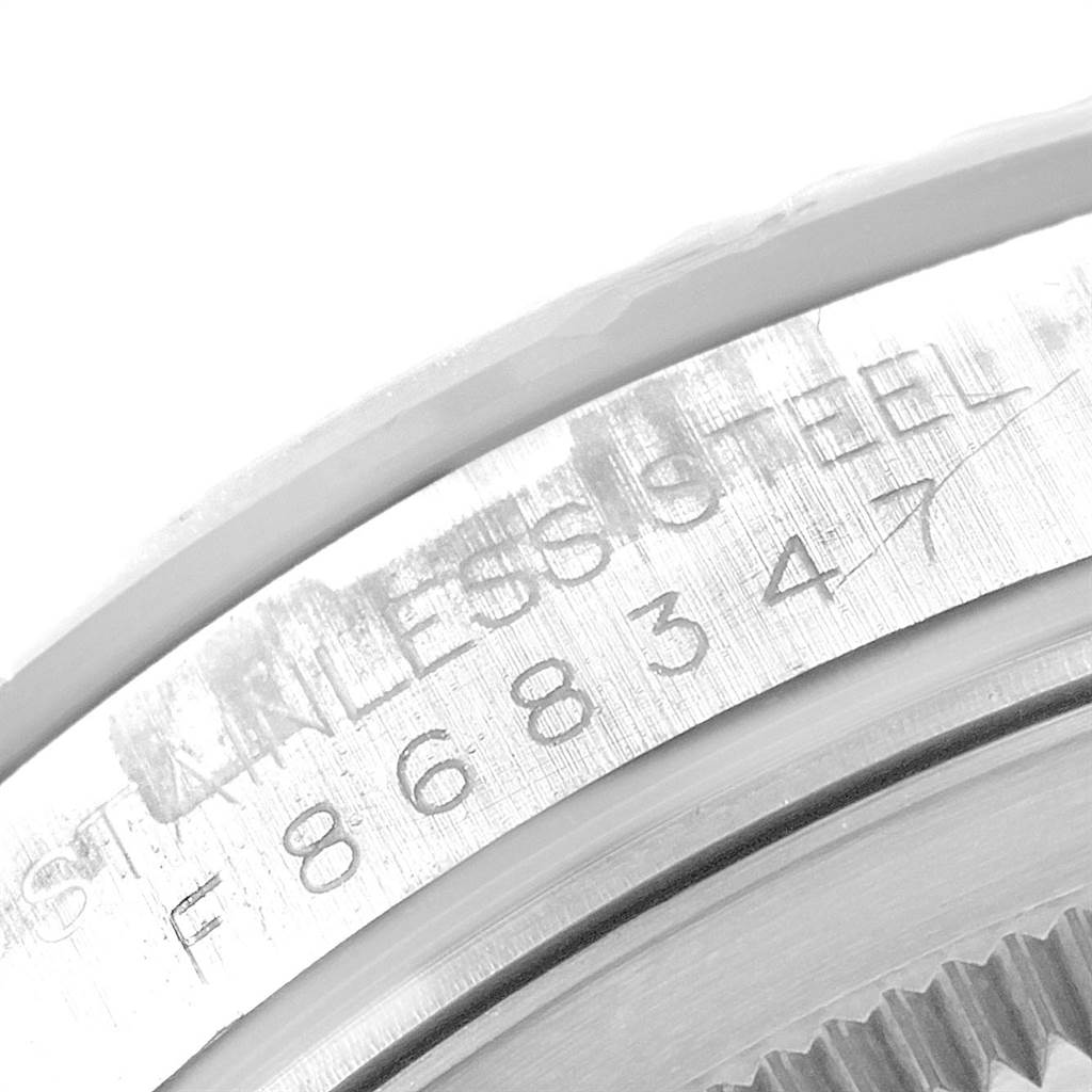 This close-up image shows the serial number and part of the bezel on a Rolex Turn-o-Graph 116264 Men
s Stainless Steel White Dial 116264 Men
s Stainless Steel White Dial watch.