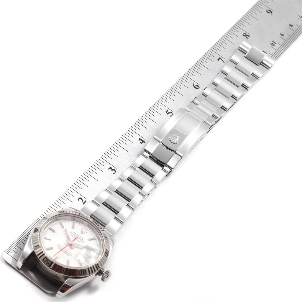 The image shows the Rolex Turn-o-Graph 116264 Men
s Stainless Steel White Dial 116264 Men
s Stainless Steel White Dial watch laid out flat, displaying the face and full length of the band next to a ruler for scale.