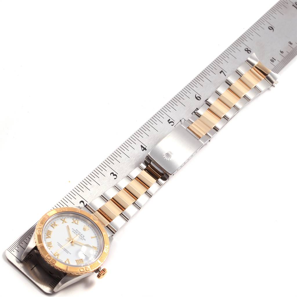 This image shows a Rolex Turn-o-Graph 16263 Men
s Steel and Gold (two tone) White Dial 16263 Men
s Steel and Gold (two tone) White Dial watch laid flat, aligned next to a ruler for measurement.