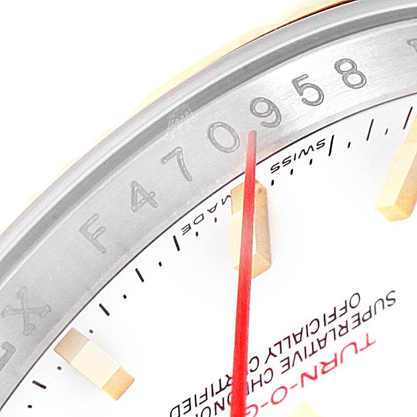 This close-up angle of the Rolex Turn-o-Graph 116263 Men
s Steel and Gold (two tone) White Dial 116263 Men
s Steel and Gold (two tone) White Dial model shows the bezel, part of the dial, and the red second hand.