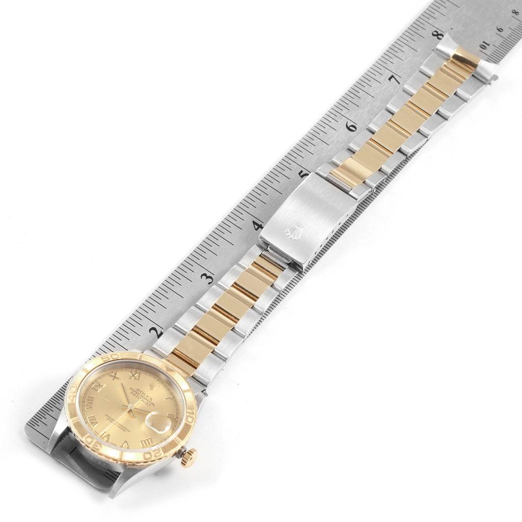 The image shows a Rolex Turn-o-Graph 16263 Men
s Steel and Gold (two tone) Champagne Dial 16263 Men
s Steel and Gold (two tone) Champagne Dial watch at a top-down angle, with its face, bezel, and bracelet alongside a ruler.