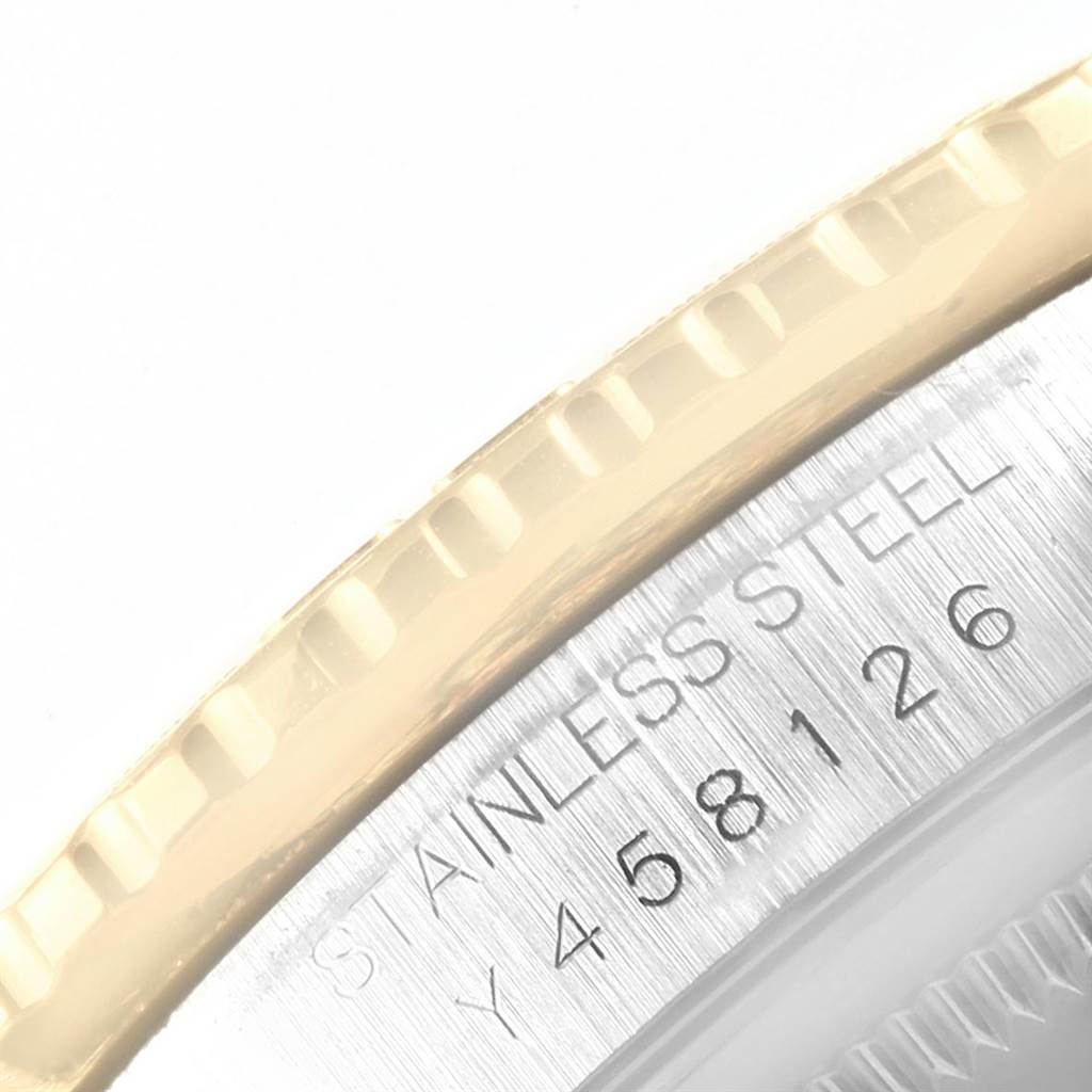 This image shows a close-up of the bezel and casing of the Rolex Turn-o-Graph 16263 Men
s Steel and Gold (two tone) Champagne Dial 16263 Men
s Steel and Gold (two tone) Champagne Dial watch, focusing on the stainless steel and part of the serial number.