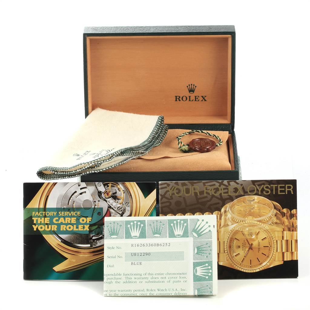 The image shows the packaging and documentation for a Rolex Turn-o-Graph 16263 Men's Steel and Gold (two tone) Blue Dial 16263 Men's Steel and Gold (two tone) Blue Dial watch, including a box, cleaning cloth, and warranty cards.