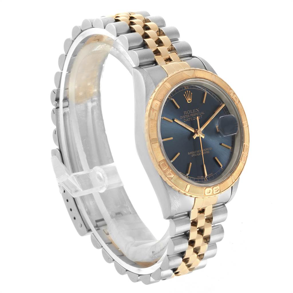 The image shows a side angle of a Rolex Turn-o-Graph 16263 Men's Steel and Gold (two tone) Blue Dial 16263 Men's Steel and Gold (two tone) Blue Dial watch, featuring a gold and silver bracelet and blue dial.