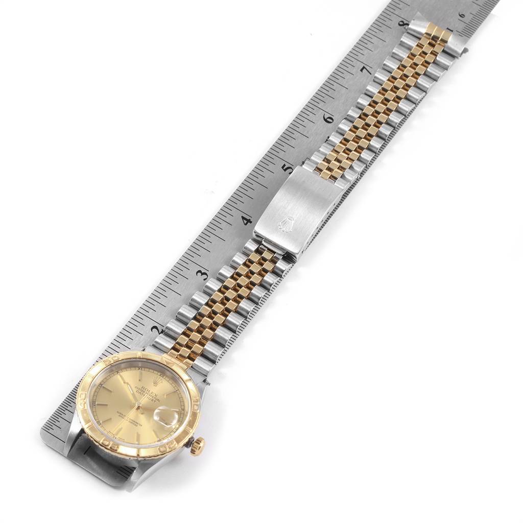 The image features a Rolex Turn-o-Graph 16263 Men
s Steel and Gold (two tone) Champagne Dial 16263 Men
s Steel and Gold (two tone) Champagne Dial watch laid flat next to a measuring ruler, showing the face and full bracelet.
