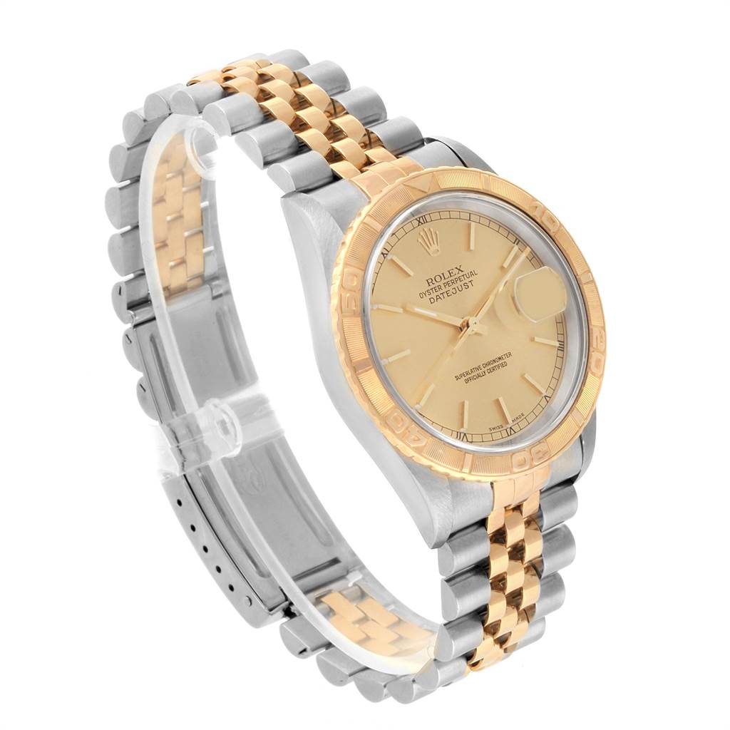 The Rolex Turn-o-Graph 16263 Men
s Steel and Gold (two tone) Champagne Dial 16263 Men
s Steel and Gold (two tone) Champagne Dial watch is shown at an angled side view, displaying its face, bezel, and two-tone bracelet band.