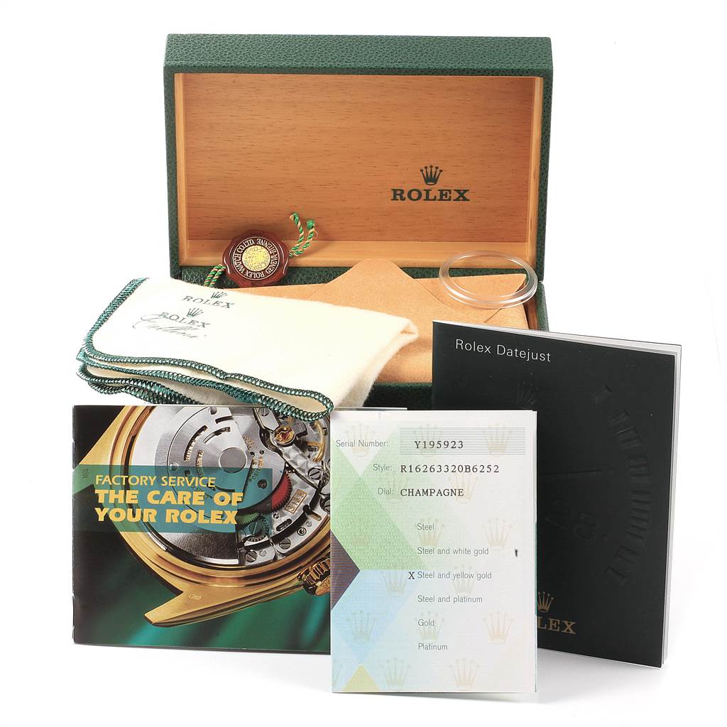 The image shows the packaging and accessories for a Rolex Turn-o-Graph 16263 Men
s Steel and Gold (two tone) Champagne Dial 16263 Men
s Steel and Gold (two tone) Champagne Dial, including manuals, tags, a polishing cloth, and a service booklet.
