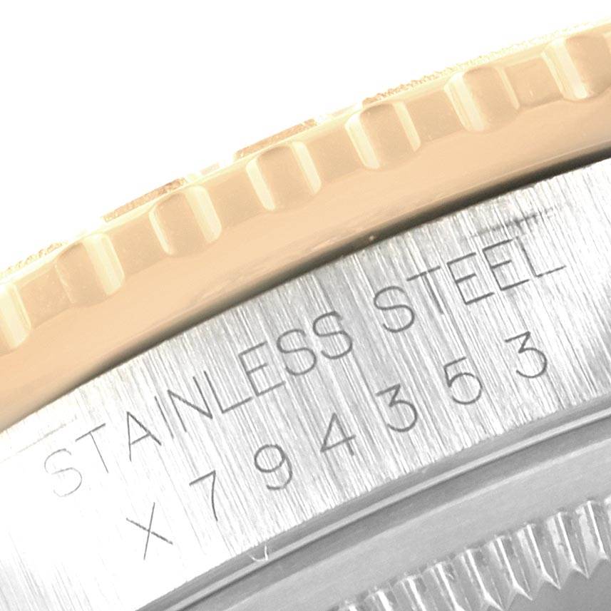This close-up image shows part of the engraved bezel and serrated edge of a Rolex Turn-o-Graph 16263 Men
s Steel and Gold (two tone) Black Dial 16263 Men
s Steel and Gold (two tone) Black Dial watch.