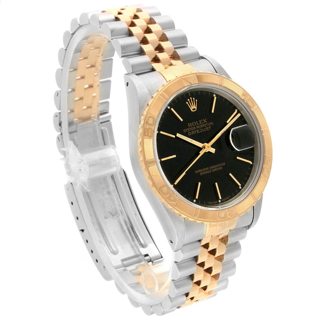 The image shows a Rolex Turn-o-Graph 16263 Men
s Steel and Gold (two tone) Black Dial 16263 Men
s Steel and Gold (two tone) Black Dial with a black dial, gold bezel, and two-tone silver and gold bracelet from a side angle.