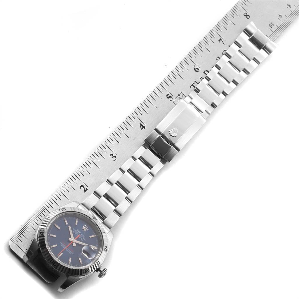 The image shows a Rolex Turn-o-Graph 116264 Men
s Stainless Steel Blue Dial 116264 Men
s Stainless Steel Blue Dial watch laid flat alongside a ruler, displaying its bracelet and clasp.