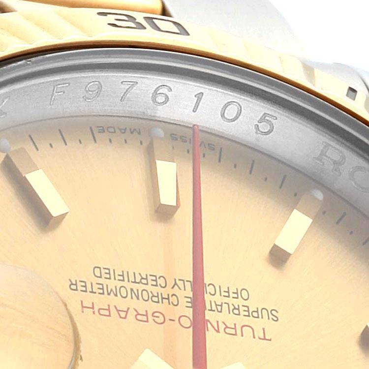 This image shows a close-up angle of the bezel, chapter ring, and part of the dial and hands of a Rolex Turn-o-Graph 116263 Men's Steel and Gold (two tone) Champagne Dial 116263 Men's Steel and Gold (two tone) Champagne Dial watch.