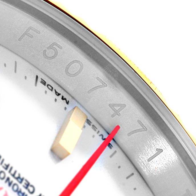 The image shows a close-up of the bezel, a part of the dial, and the red second hand of the Rolex Turn-o-Graph 116263 Men
s Stainless Steel White Dial 116263 Men
s Stainless Steel White Dial watch.