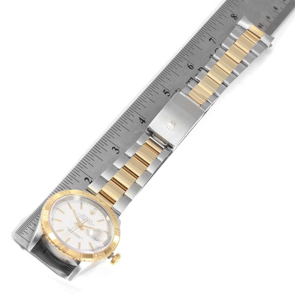 This image shows a Rolex Turn-o-Graph 16263 Men
s Steel and Gold (two tone) White Dial 16263 Men
s Steel and Gold (two tone) White Dial watch laid flat next to a ruler, highlighting the face, bezel, bracelet, and clasp.