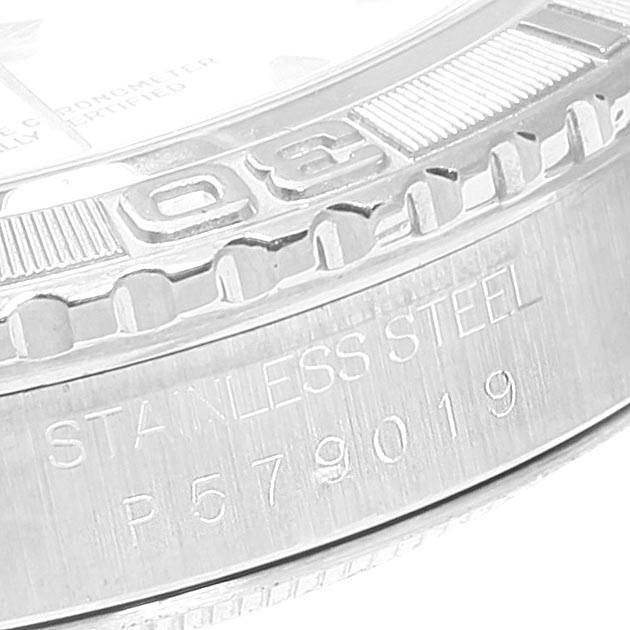 The image shows a close-up side view of the bezel and case of a Rolex Turn-o-Graph 16264 Men
s Stainless Steel White Dial 16264 Men
s Stainless Steel White Dial watch, highlighting the engravings "STAINLESS STEEL" and a serial number.