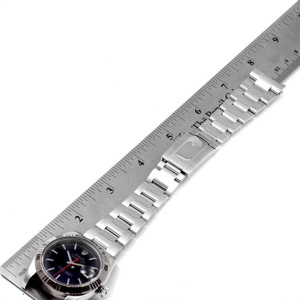 The image shows a side view of a Rolex Turn-o-Graph 116264 Men
s Stainless Steel Black Dial 116264 Men
s Stainless Steel Black Dial watch, displaying its stainless steel bracelet and clasp alongside a ruler for size reference.